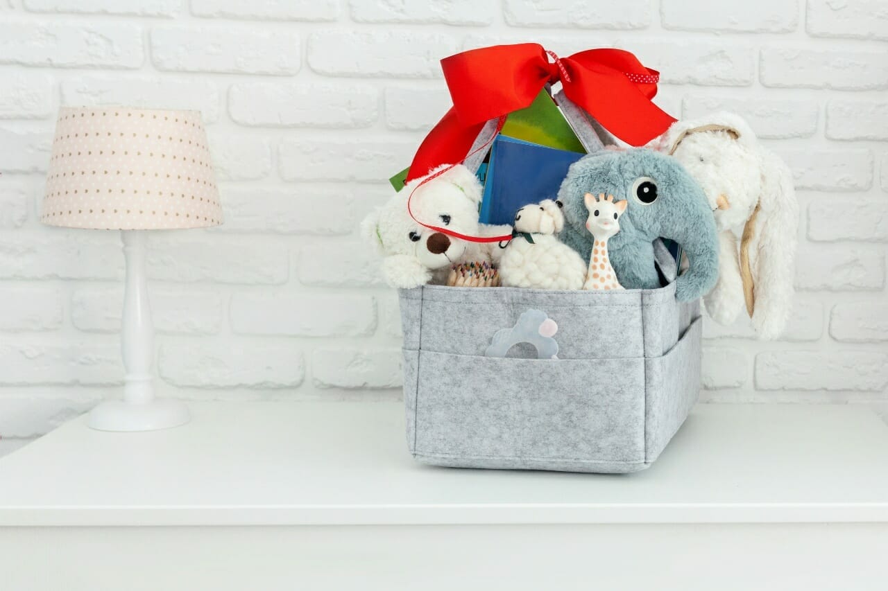 mothers-bag-with-toy-diapers-and-accessories-on-white