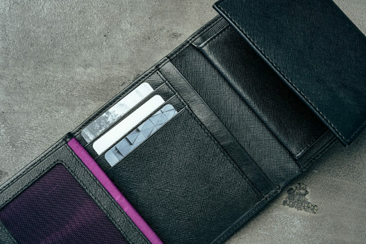 black-new-leather-wallet-on-grey-concrete-background