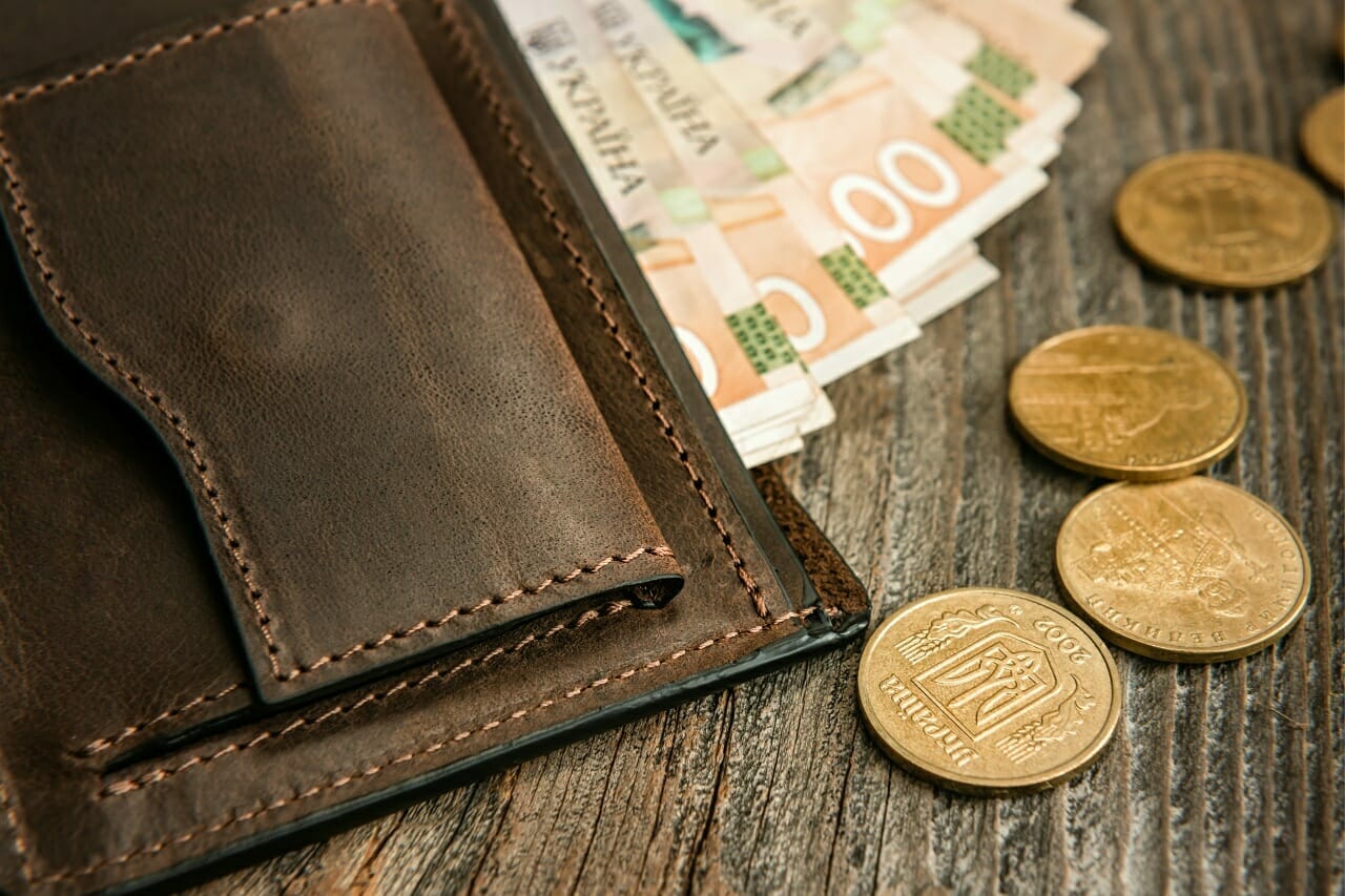 brown-leather-wallet-with-banknotes-and-coins