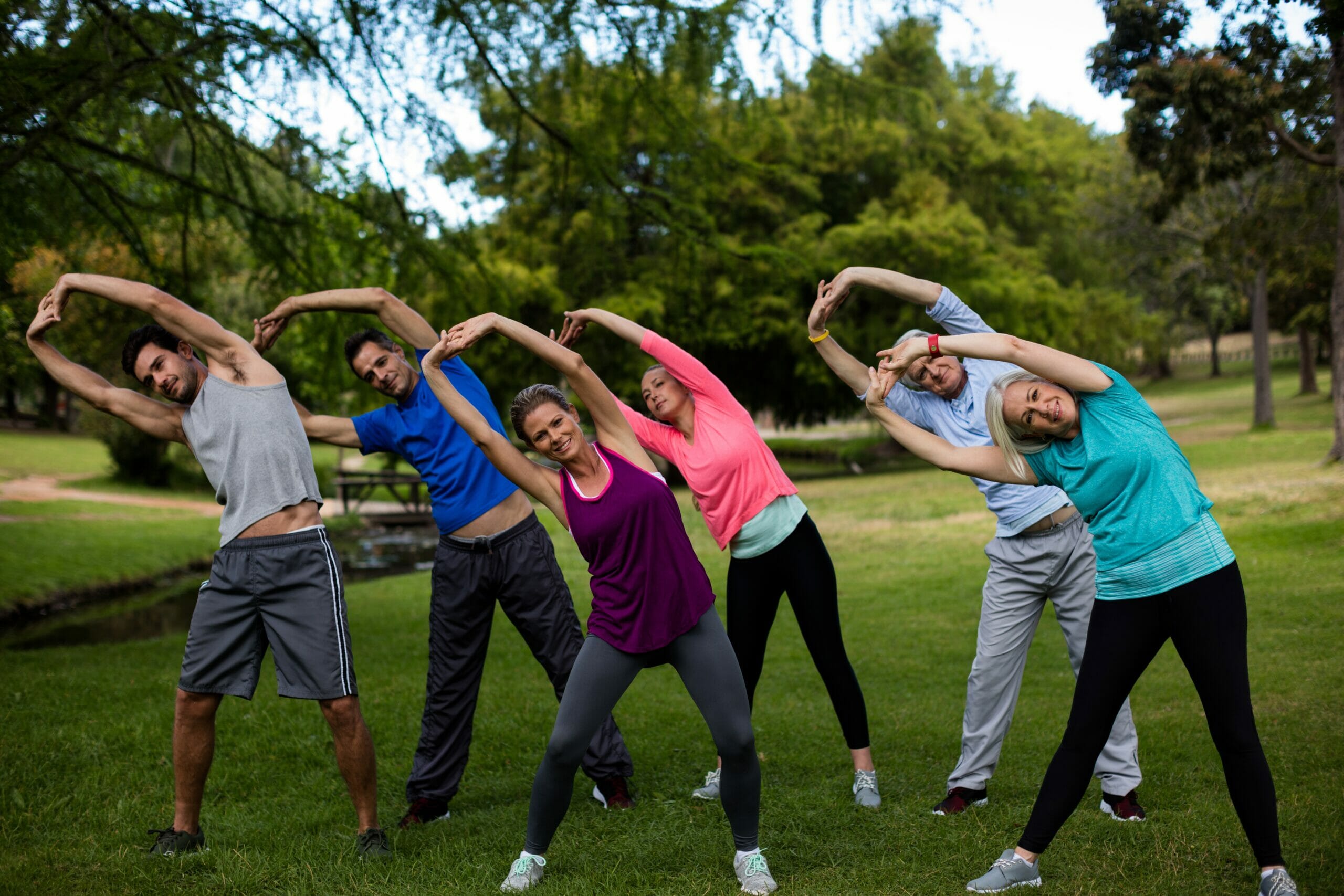 Group of people performing stretching exercise