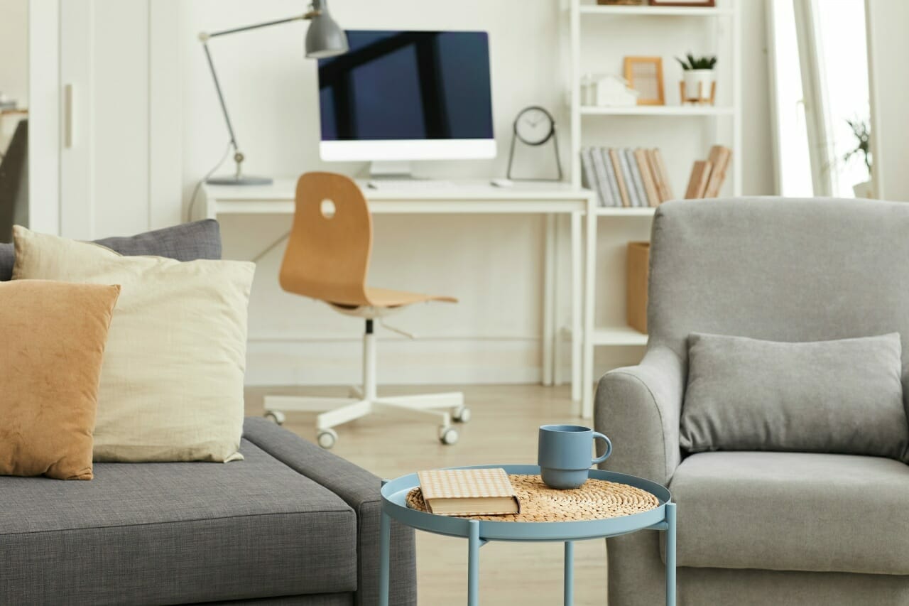 detail-image-of-cozy-apartment-interior-in-modern-home-with-focus-on-grey-living-room-furniture-in-foreground