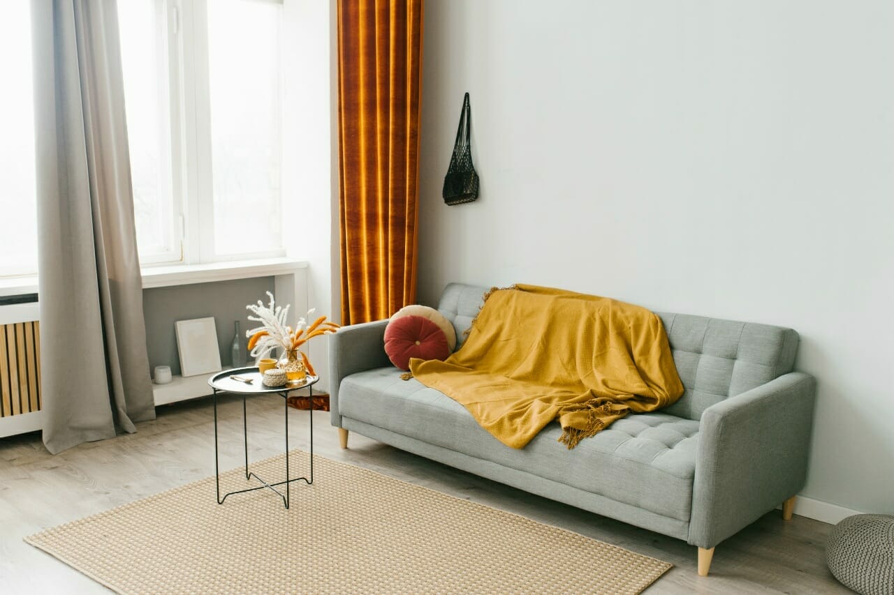 grey-sofa-in-the-living-room-in-a-scandinavian-minimalist-natural-style-with-yellow-and-red-colo